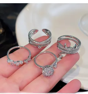 Detail shot of four adjustable silver rings featuring zircon hearts and cat motifs