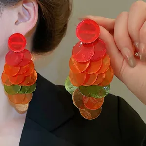 Colorful tiered shell drop earrings featuring layered round discs for a trendy vacation look