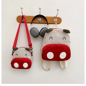 Detail of cute animal backpack set in beige and red with durable canvas fabric