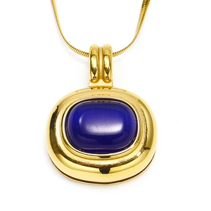 Macro detail of vintage gold blade chain featuring a large oval blue natural stone pendant