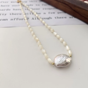 Elegant Baroque freshwater pearl necklace with gold accents on a minimalist background