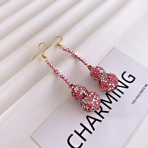 Detail of pink crystal gourd tassel earrings featuring shimmering pavé set rhinestones
