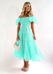 Detail of mint green off-shoulder dress with puff sleeves and textured plaid fabric