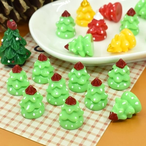 Macro shot of miniature resin Christmas trees with white polka dots for DIY holiday crafts