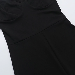 Close-up of black lace trim detailing and stitching on a backless strapless jumpsuit