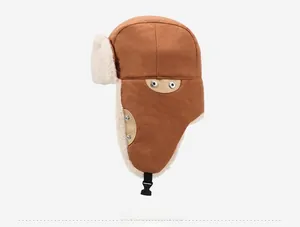 Detail view of winter trapper hat with brown canvas exterior and warm faux fur lining
