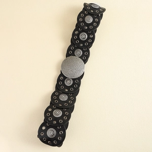 Close-up of vintage black PU leather waist belt with textured silver metal round plates