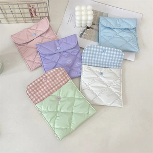 Detailed view of quilted nylon sanitary bag with snap closure and checkered inner lining
