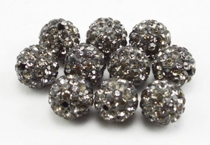 Macro detail of 8mm smoky grey pavé clay disco beads for jewelry making and crafting