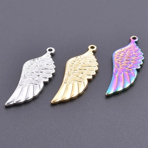 Detailed view of wing-shaped pendants in silver, gold, and rainbow metallic finishes
