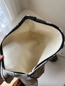 Interior view of floral canvas makeup bag with thick lining and metal zipper