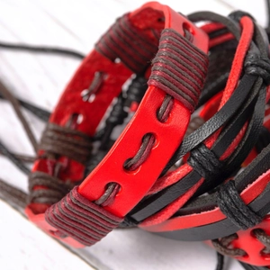 Close-up of vintage multi-layer woven leather bracelet in red and black braided cord