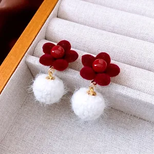 Elegant red flocked flower earrings with white faux fur pom poms and gold metal accents