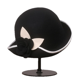 Elegant black wool cloche hat for women with camellia floral accent and white contrast brim