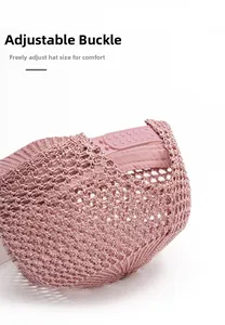 Detail of pink woven mesh baseball cap featuring an adjustable plastic snapback closure