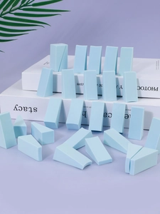 Detailed close-up of non-latex wedge makeup sponges in light blue for makeup base