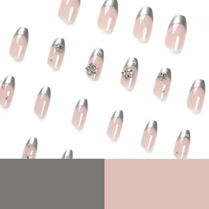 French tip press-on nails in nude pink with silver metallic stars and 3D bead accents
