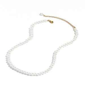 Close-up of round white pearl necklace with 14K gold lobster clasp and extension chain