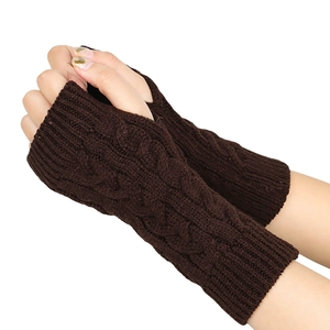 Detailed texture of dark brown cable knit fingerless gloves and wrist warmers