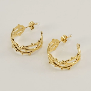 Detailed macro view of gold-plated hollow line hoop earrings with small bead decorations