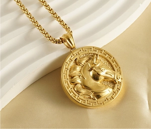 Macro shot of 3D horse head embossed gold pendant necklace with square link chain