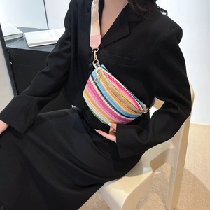Bohemian colorful striped woven fanny pack with wide shoulder strap worn by a model