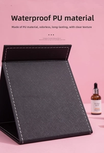 Macro detail view of the black textured PU leather cover on foldable makeup mirror