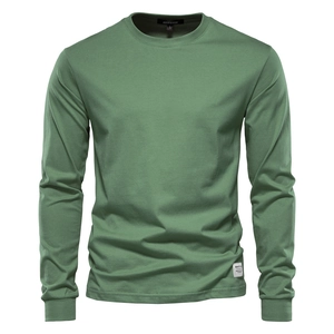 Detail of sage green cotton t-shirt showing round neckline and premium knitted texture