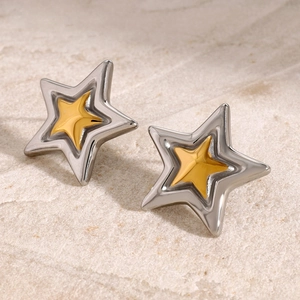 Detail of two-tone star studs with polished silver and gold metallic finish on stone