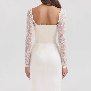 Detail of elegant backless wedding dress featuring delicate lace sleeves and satin fabric