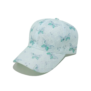 Detail of light blue lace baseball cap with butterfly embroidery and breathable mesh