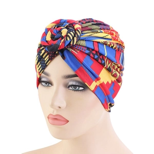 Detailed knit texture of ethnic pattern turban with vibrant red and blue geometric prints