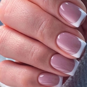 Classic French tip press-on nails in soft pink and white with a glossy square-oval shape