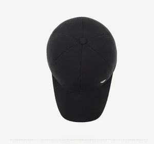 Top down view of black winter baseball cap with waffle texture and metal logo