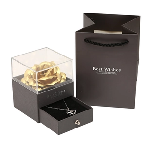 Luxurious gift set featuring a golden rose and silver necklace in a gray jewelry box
