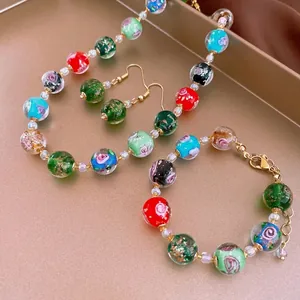 Handmade lampwork bead jewelry set with floral patterns and gold-plated chains
