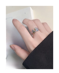 Close-up of a vintage S925 silver ring featuring colorful opal and pavé zircons on finger