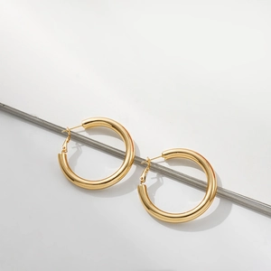 Detailed view of chunky 18K gold plated stainless steel hoop earrings with high polish