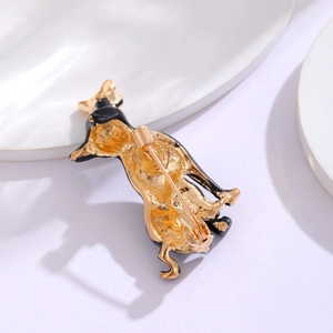 Back view of black enamel dog brooch featuring gold-plated metal base and pin closure