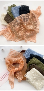 Close-up of floral lace embroidered triangular scarves in multiple colors with scalloped edges