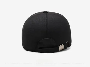 Detail view of the back of a thick winter baseball cap with wool texture and metal buckle