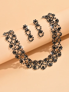 Detail of elegant black crystal necklace and earrings jewelry set in silver setting