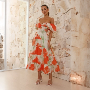 Detail of off-shoulder puff sleeves and floral print on a white summer maxi dress