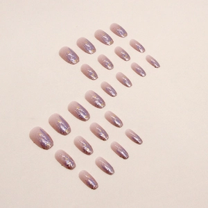 Pink and purple gradient press-on nails with glitter and gold star accents, short ballet style