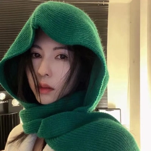 Detail of green knitted hooded scarf for women showing warm neck wrap texture