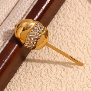 Detailed macro of vintage 18K gold-plated egg-shell hair clip with sparkling rhinestones