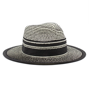 Macro detail of the woven texture on a black and white striped straw Panama hat