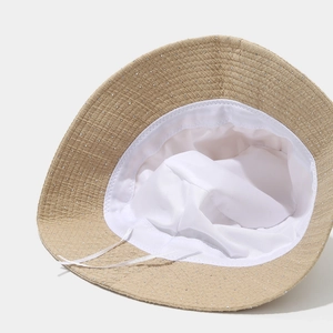 Beige bucket hat with sparkling rhinestones and adjustable white lining drawstring