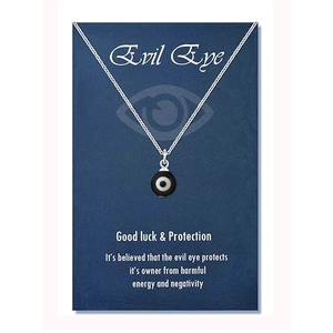 Detail of evil eye amulet necklace on a blue card with good luck protection message