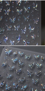 Detailed holographic butterfly nail stickers with laser rainbow reflection on grey background